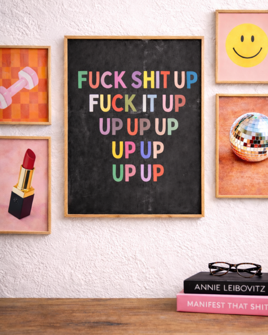 Bold “fuck shit up” motivational wall art print with multicolor typography on a black background, styled in a modern creative space.
