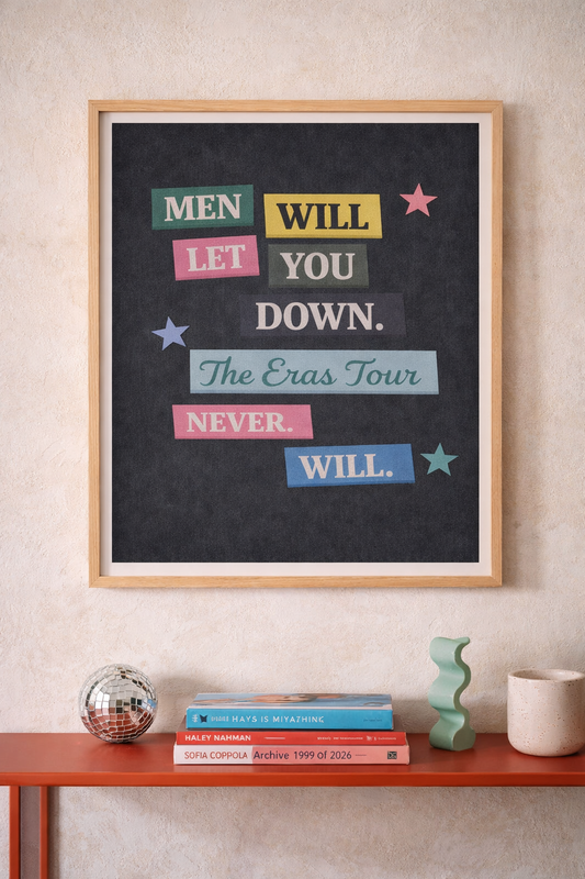 Framed art print reading “Men will let you down. The Eras Tour never will” displayed on a light plaster wall with modern decor